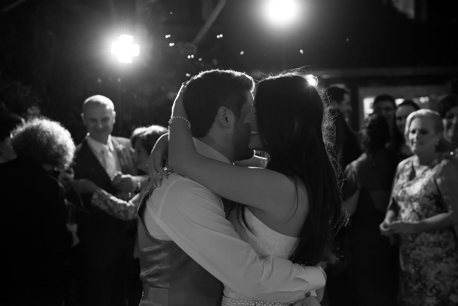 A tender dance moment between a couple at their evening celebration.