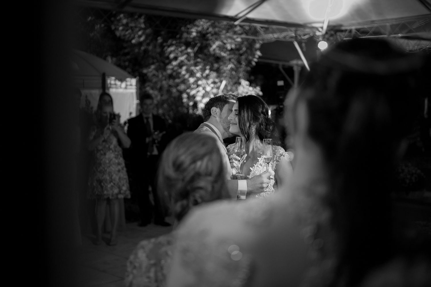 A romantic moment between a couple during their evening celebration.