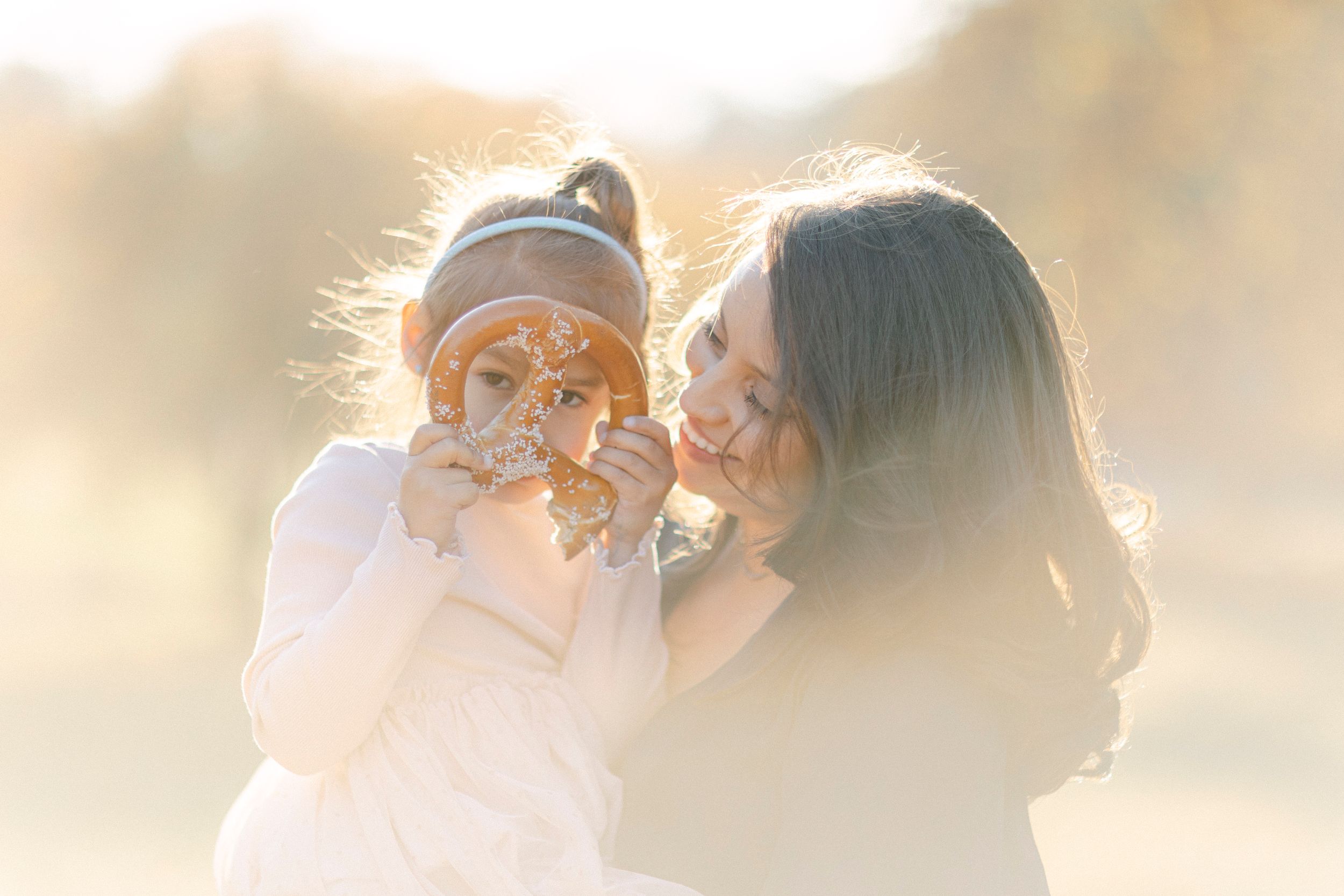 A joyful shared moment between two people laughing in golden sunset light.