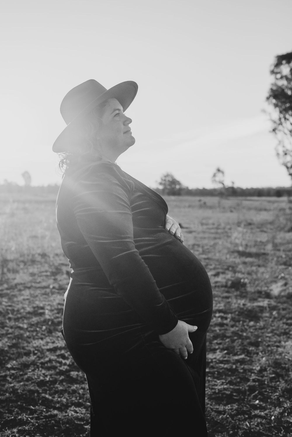 A silhouette portrait against a bright sky in the Australian countryside.