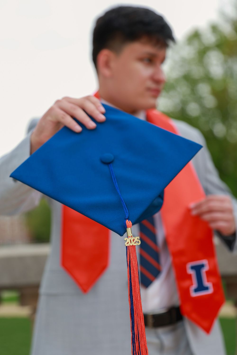 Blue graduation cap with red tassel captured in a dynamic motion sequence.