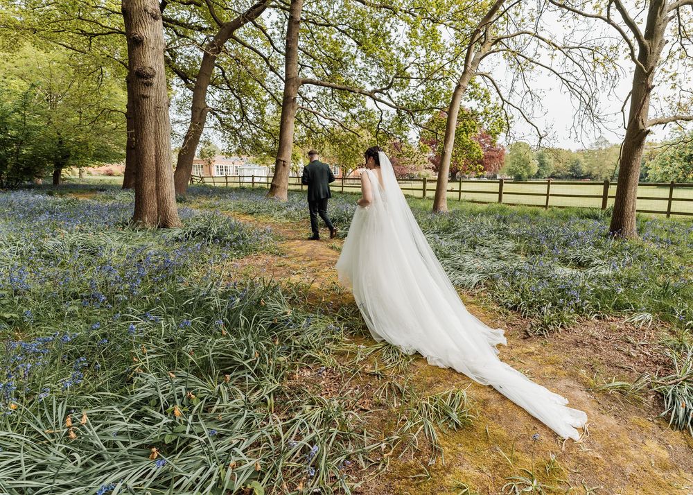 bride and groom walking in the woods together during wedding shoot in nottinghamshire