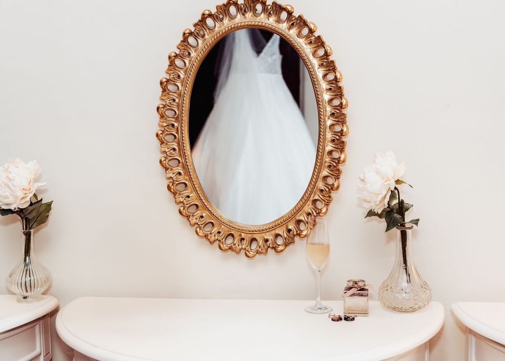 wedding dress in mirror taken during bridal prep in a wedding shoot in the peak district