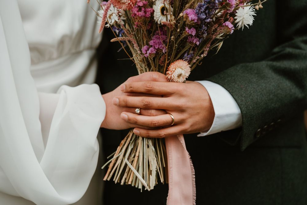 bride and groom holding hands with flower bouquet during wedding shoot in nottinghamshire