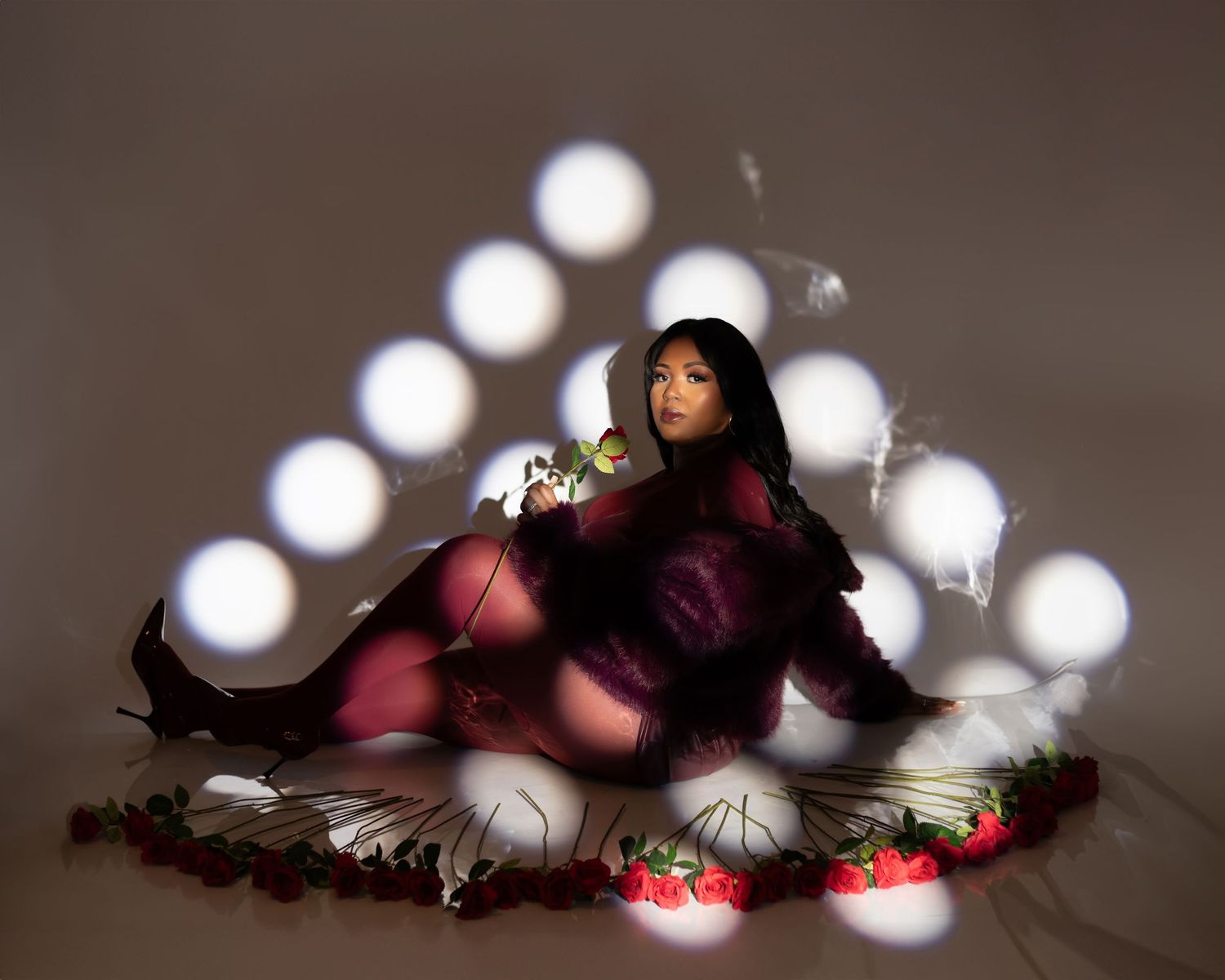 A string of glowing white lights creates a create triangle shape of round spot lights and dreamy bokeh effect with a dark background.