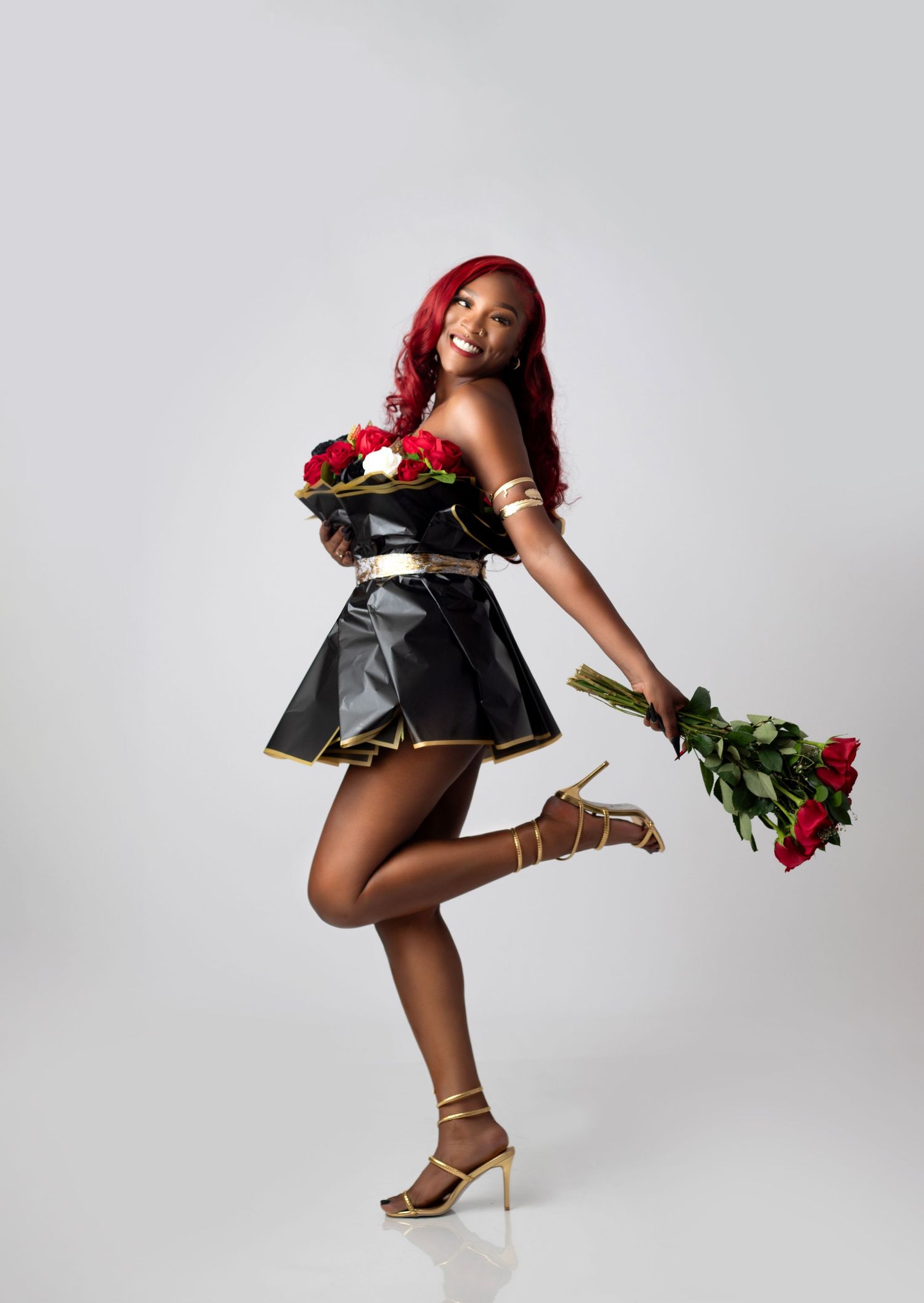 A dynamic photo sequence showing a women holding red roses while performing graceful movements at E.A. Larkins Photography Akron studio.