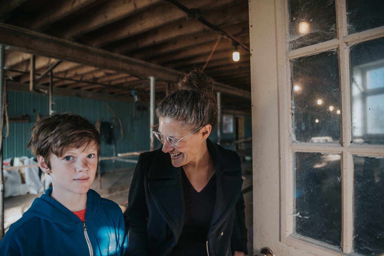 A mother smiles at her son.