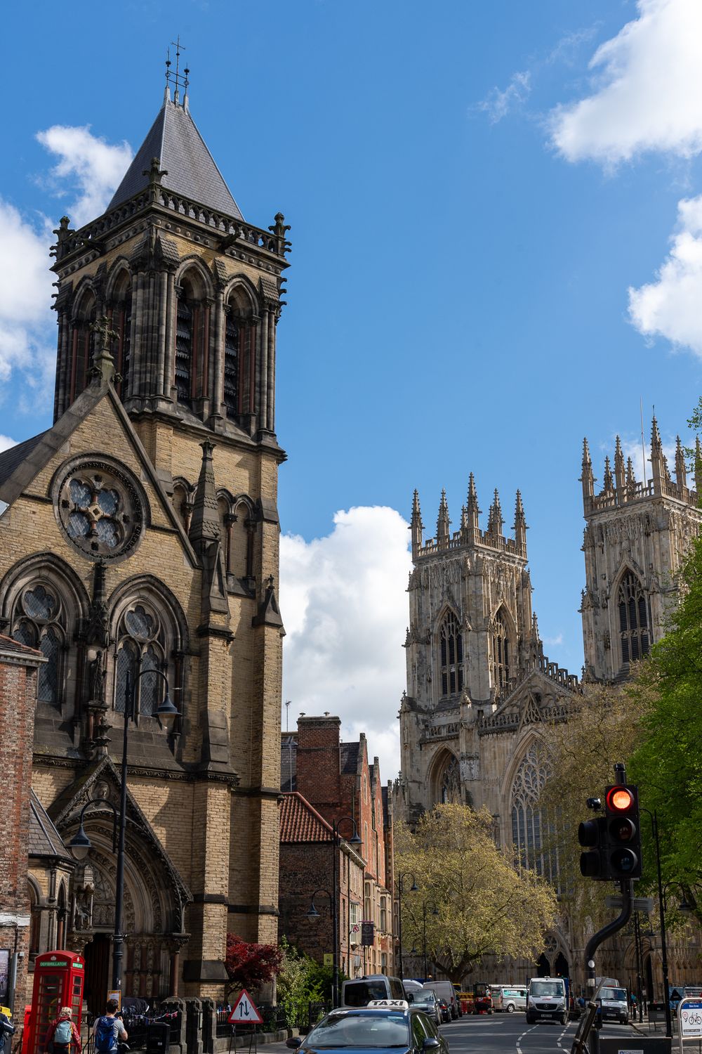 Gothic church spires and York Minster cathedral rise above city streets in York, England.