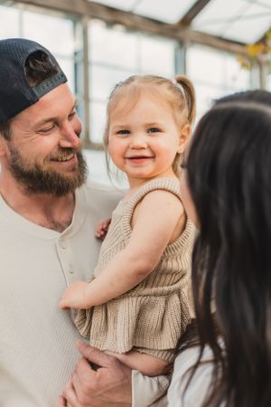 A happy family shares joyful moments together in a bright indoor setting.