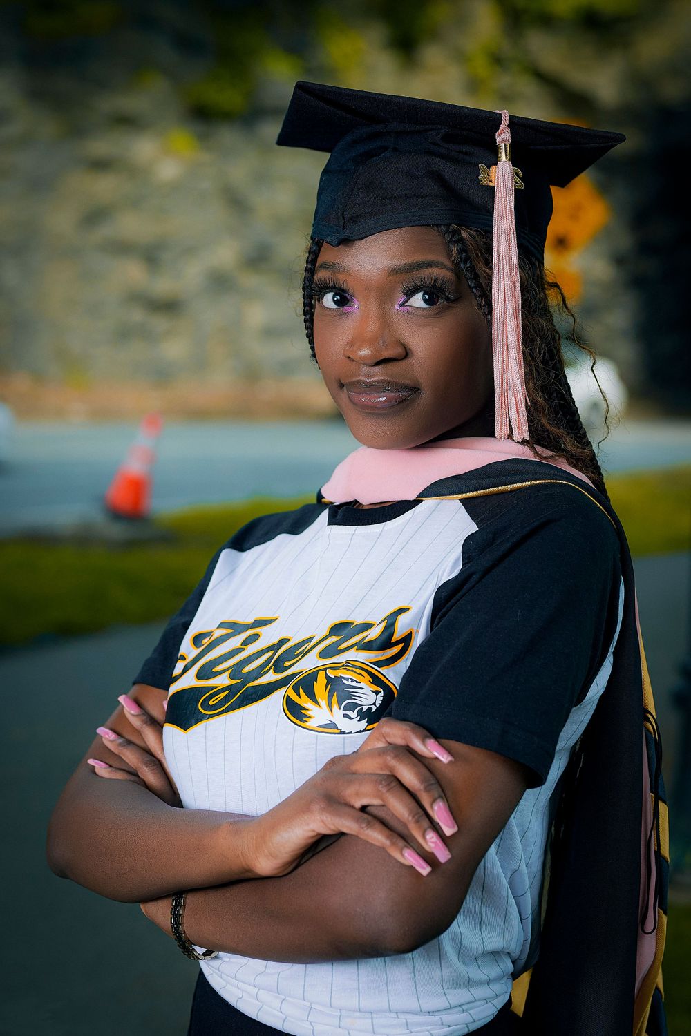 Close-up graduation portraits showing proud poses in cap and gown with Tigers logo visible.
