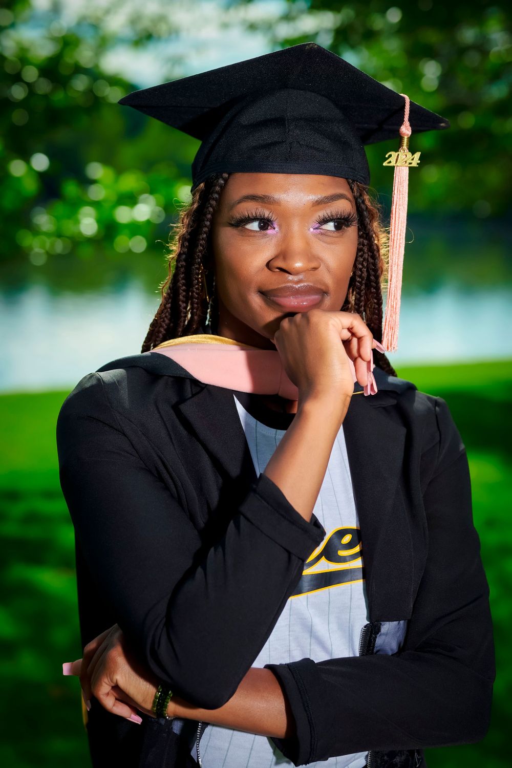 Candid graduation portrait series showing emotional moments in traditional cap and gown.