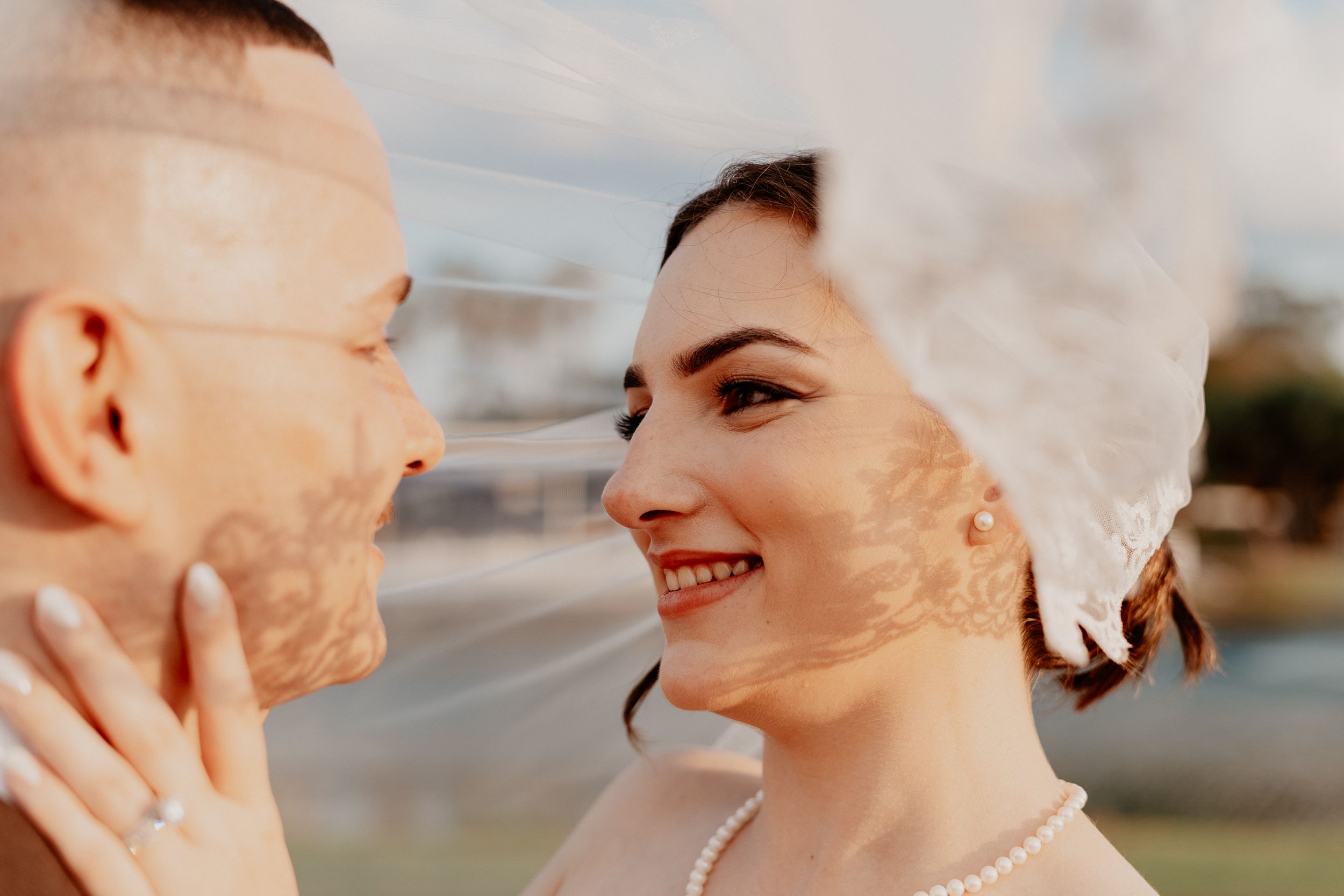A series of five close-up profile shots showing tender moments between a couple outdoors.