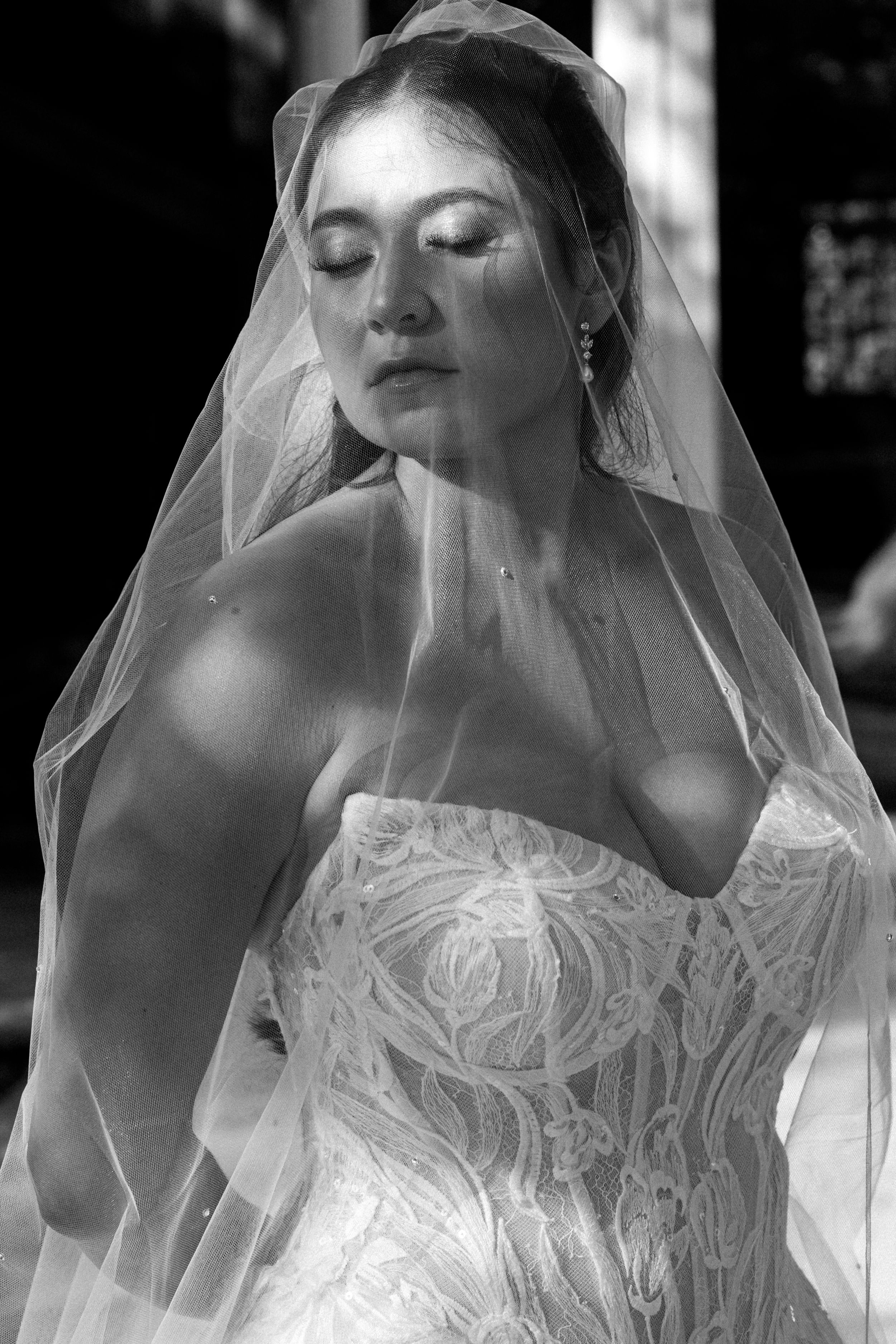 Ethereal black and white bridal portraits showing flowing veil and lace details.