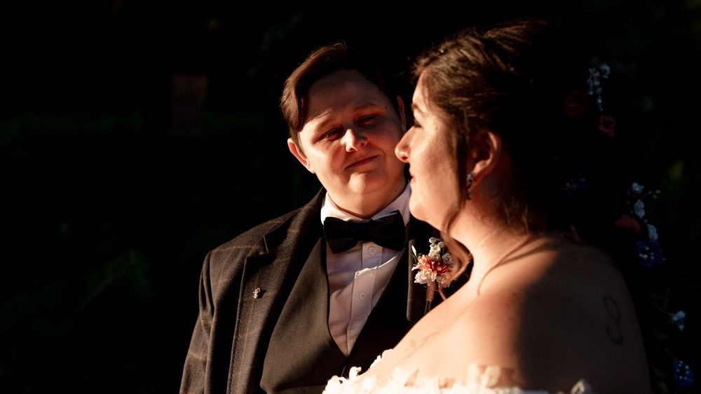 A romantic moment between a couple in formal attire dancing at an elegant evening event.