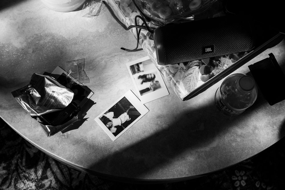 A series of black and white photographs showing dramatic shadows and light patterns on various surfaces.