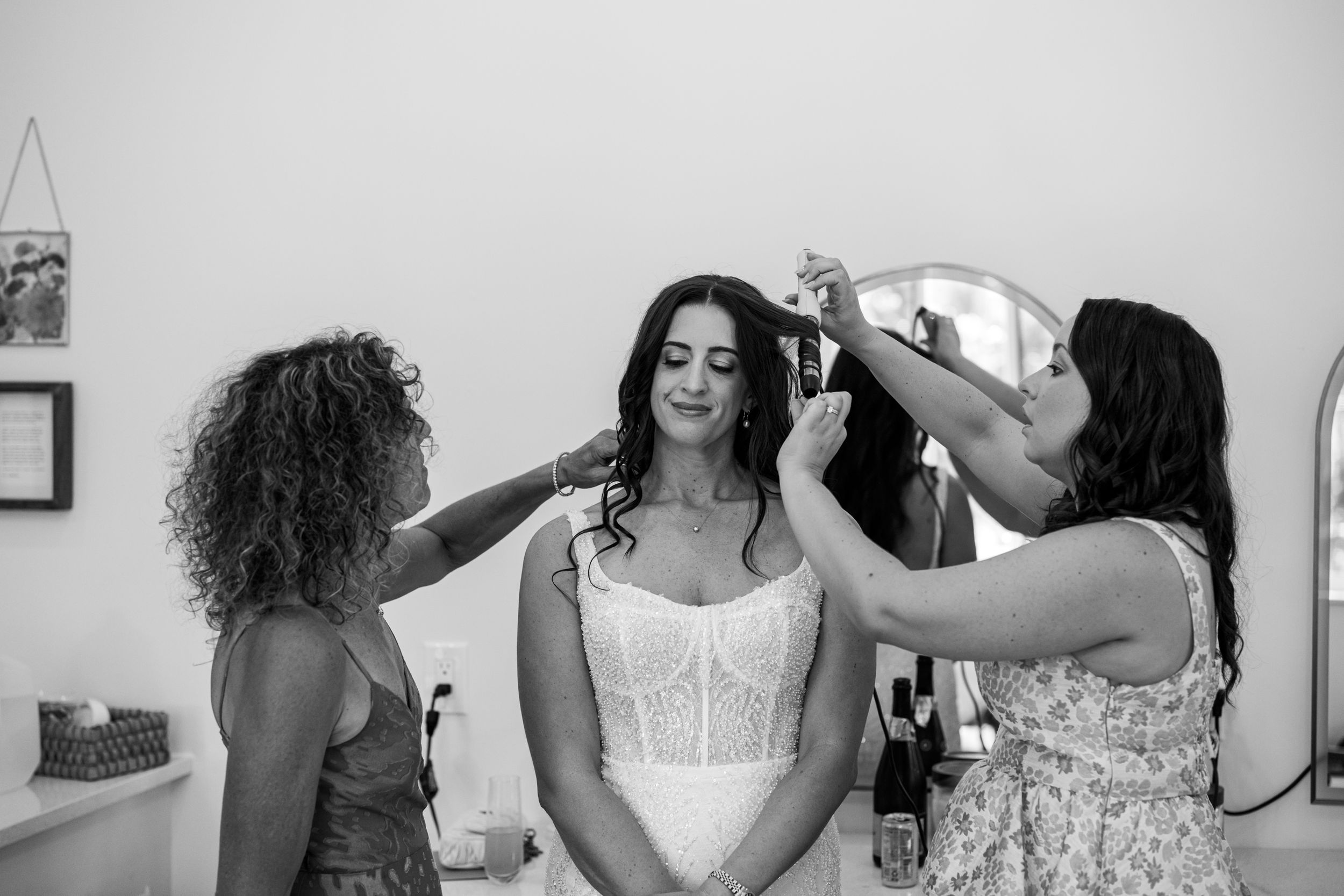 A black and white collage of wedding preparation moments showing people getting ready in formal attire.