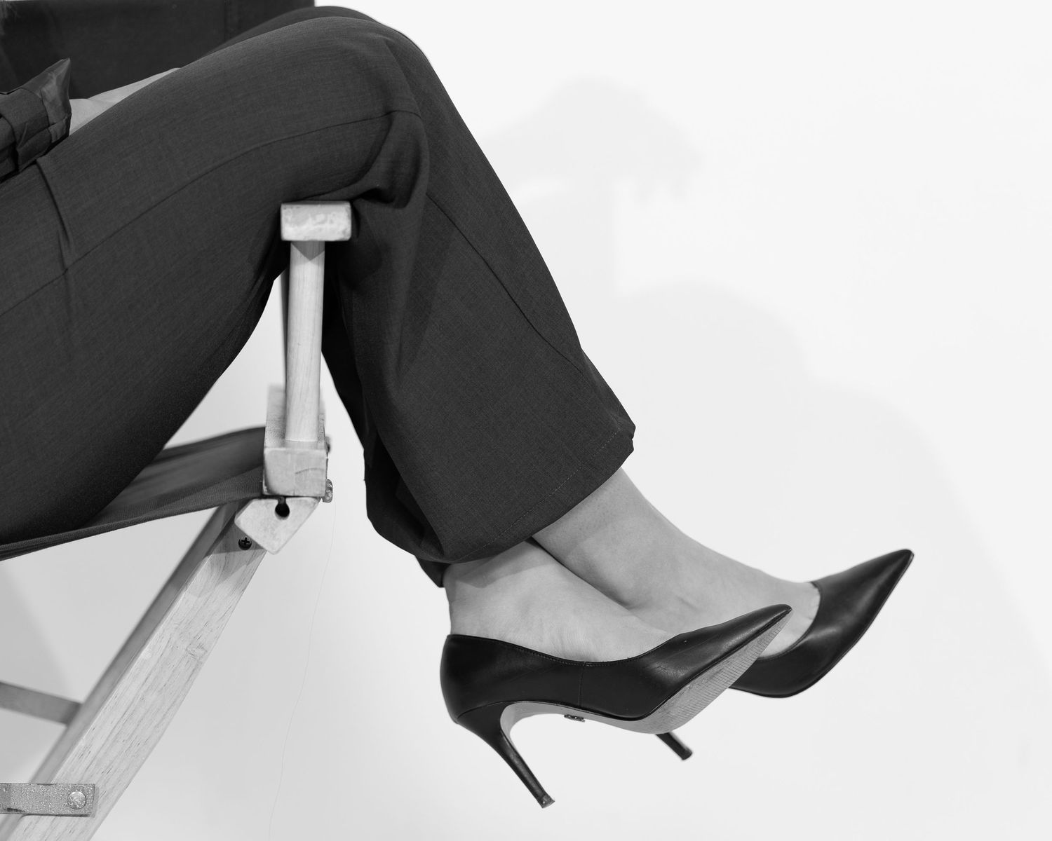 Picture of feet hanging from director chair for a social media management session. Social media person in logan UT studio.
