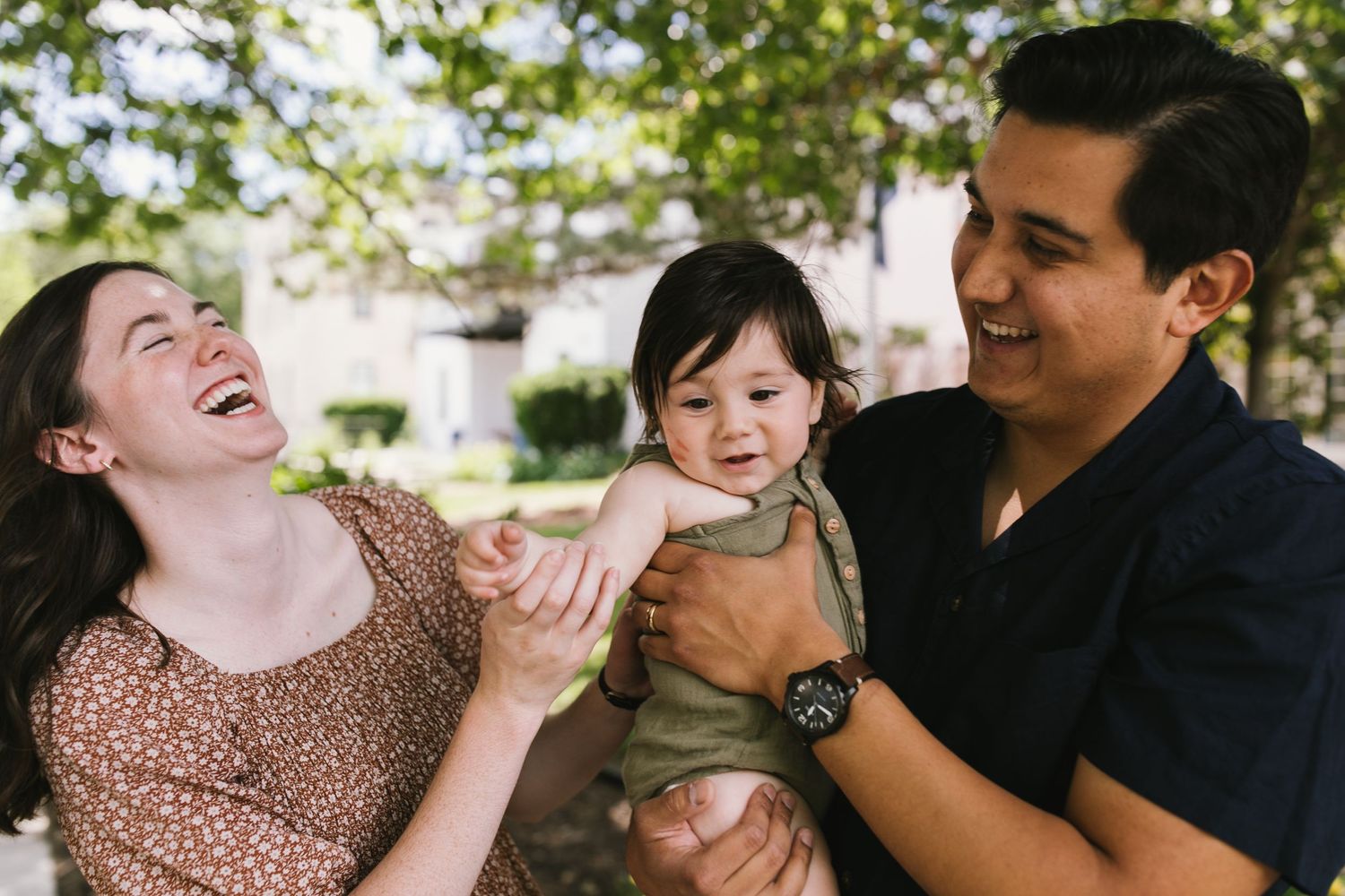 Family sharing a joyful moment outdoors in natural lighting.