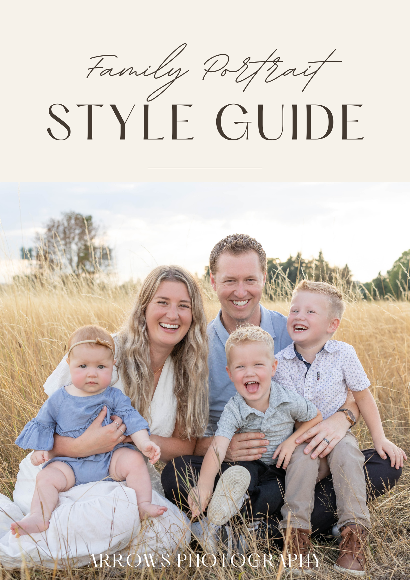 Family of five laughing together in golden grass field for portrait session.