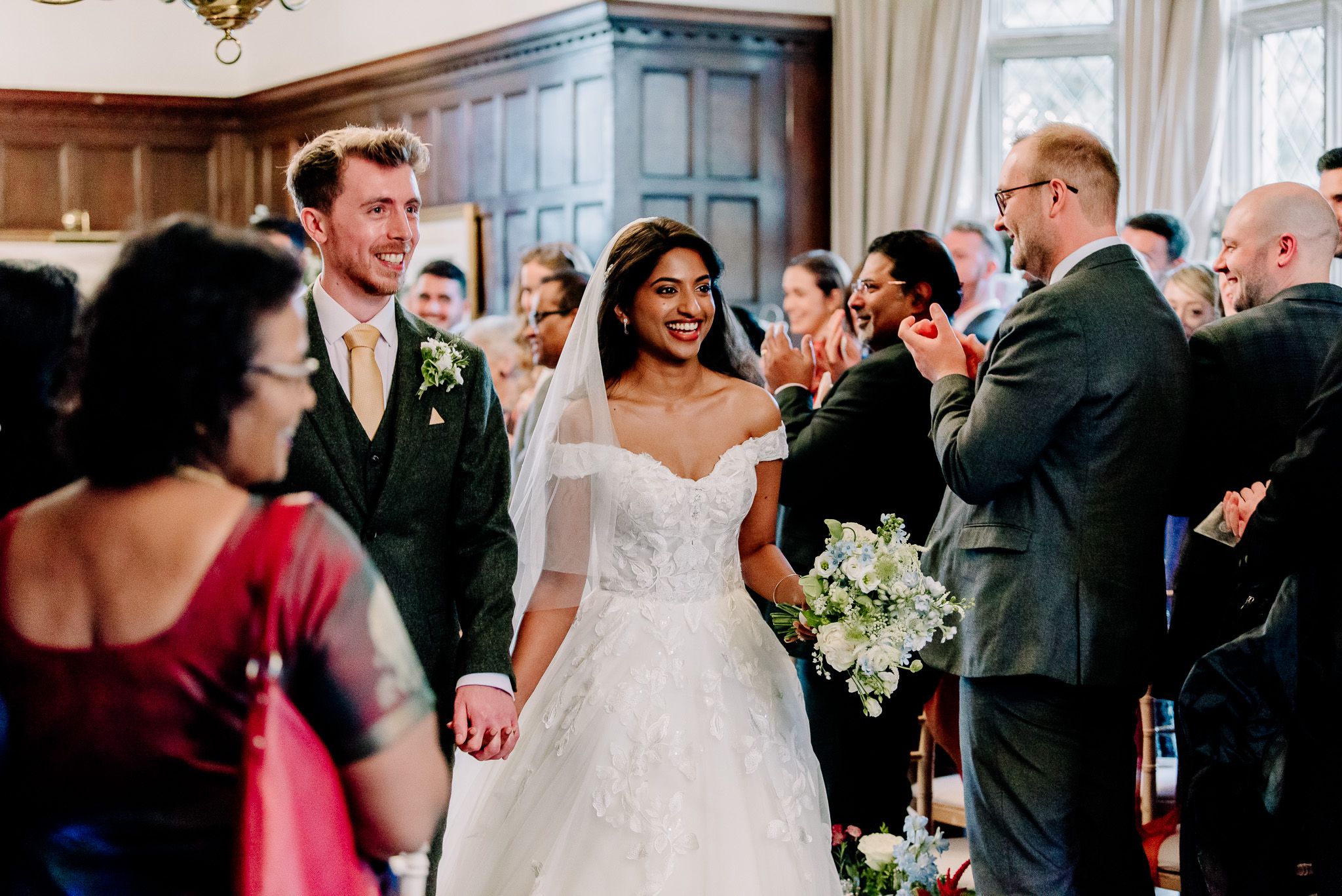 Wedding reception celebration with guests mingling in an elegant indoor venue.