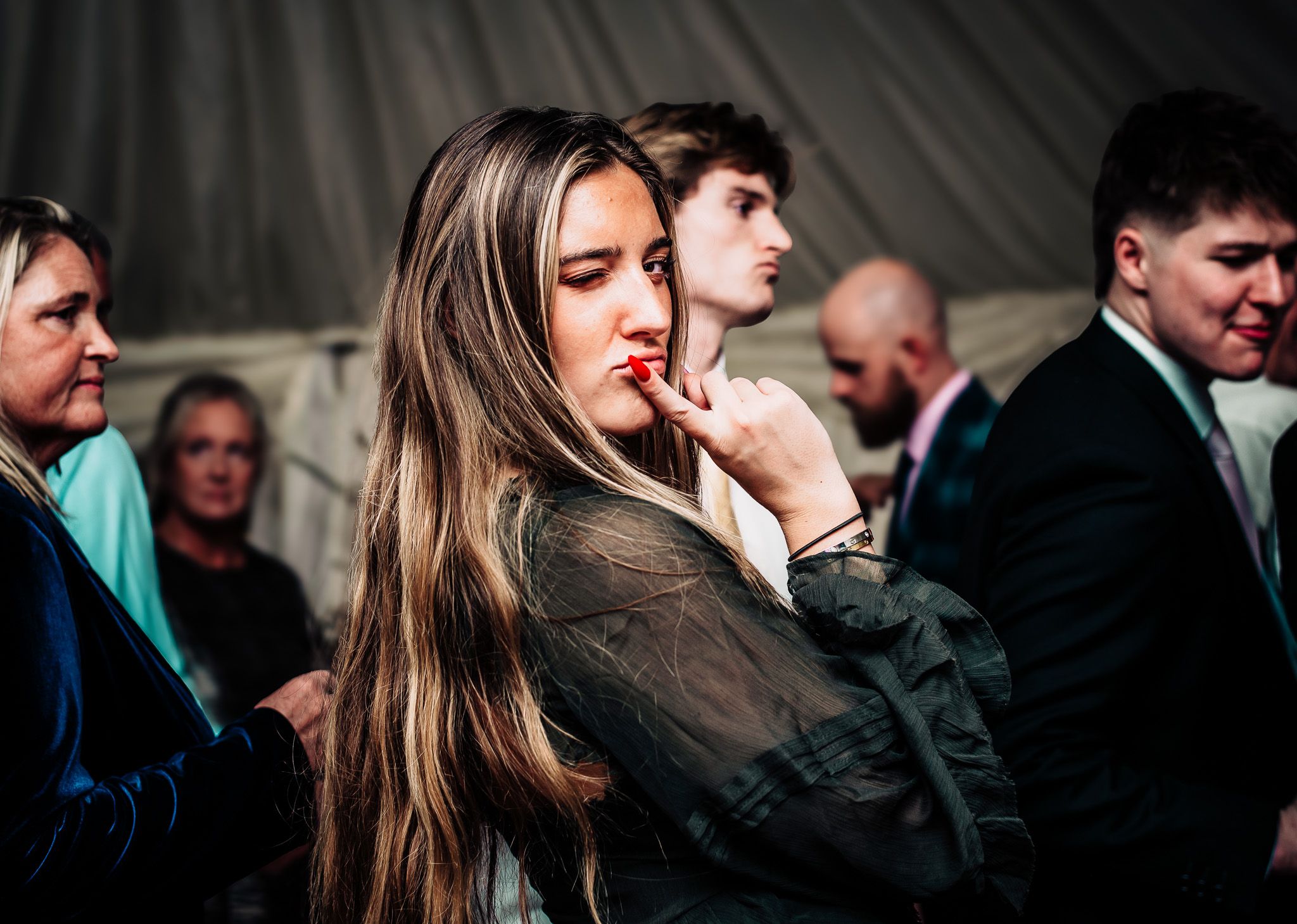 Wedding guests mingling at evening reception in formal attire.