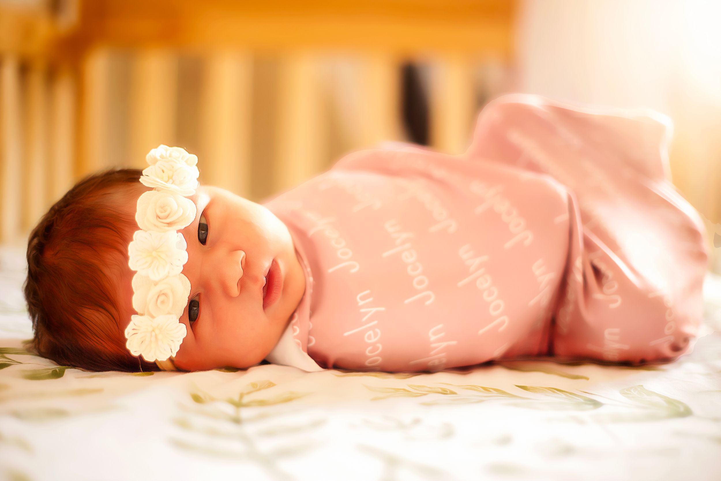 Newborn looks at camera wearing floral headband Family photography Ellensburg, Washington