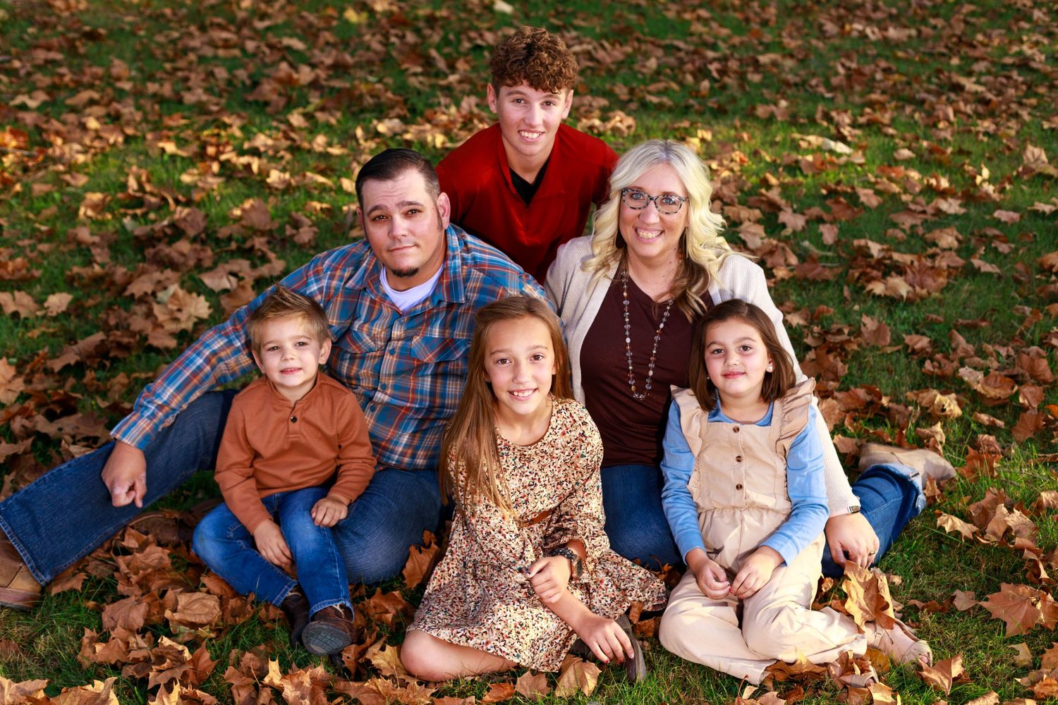 Mattoon, Illinois hairdresser and family cuddle up in a park for a sweet family portrait.