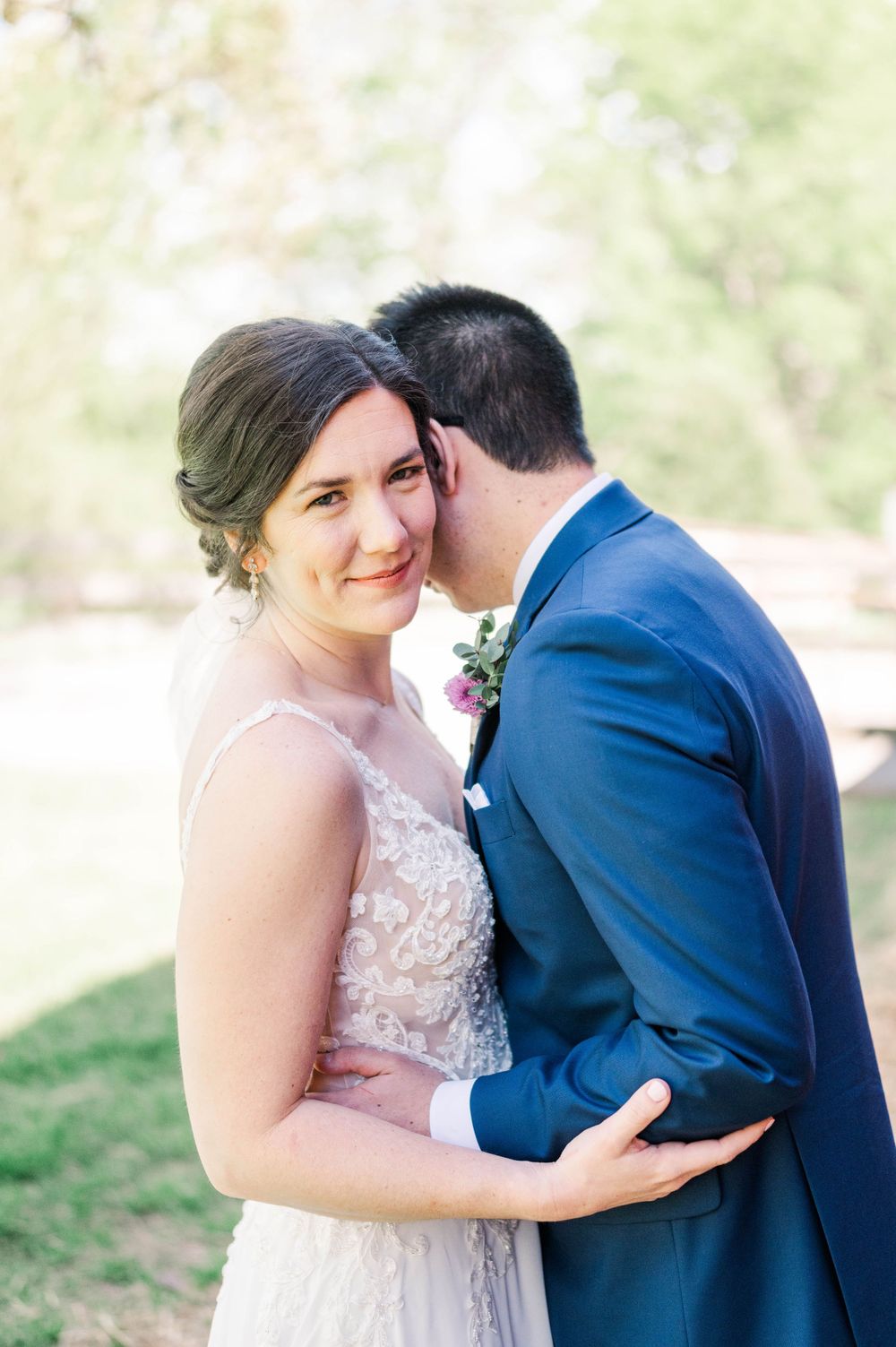 Romantic outdoor wedding portrait with soft natural lighting.