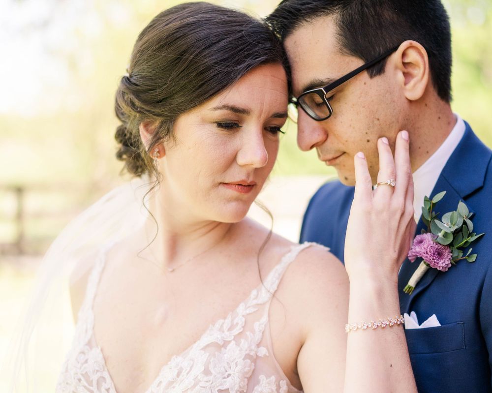 A close-up wedding portrait showing delicate lace details and soft romantic expressions.