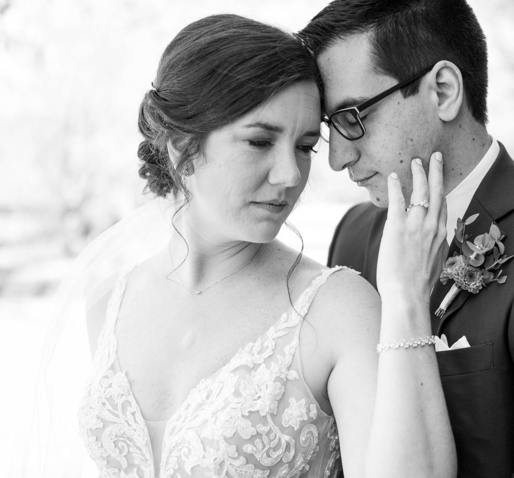 An emotional black and white portrait showcasing tender expressions between newlyweds.