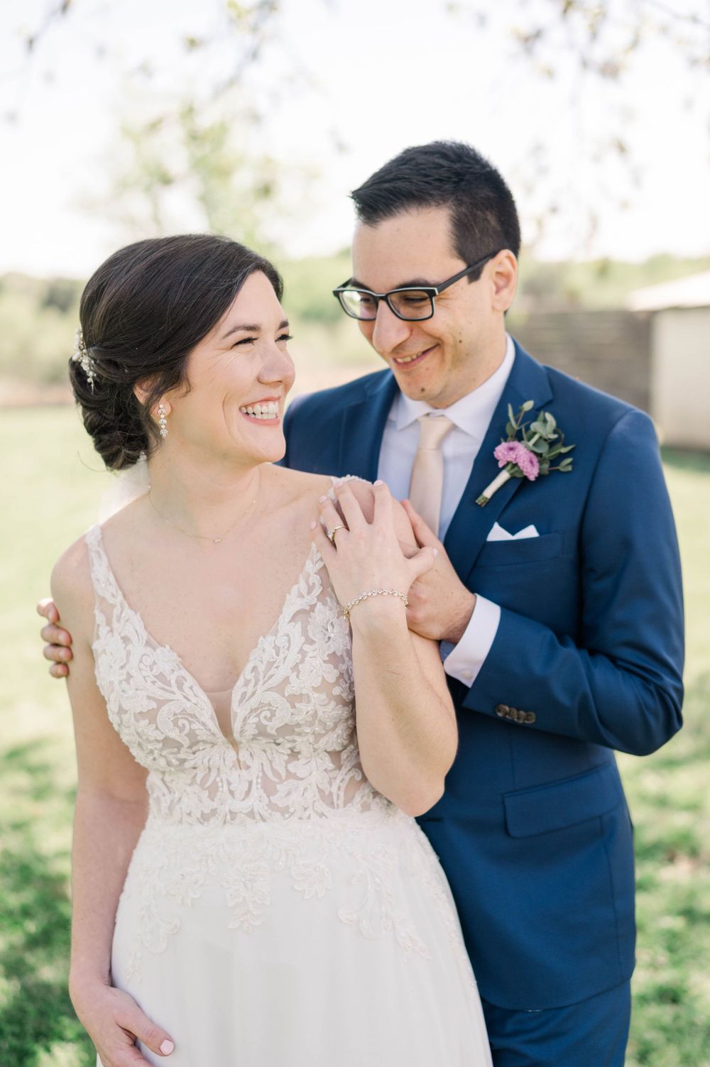 Joyful wedding couple sharing a sweet moment in outdoor spring setting. The 1932 Barn Venue, Charlotte, NC