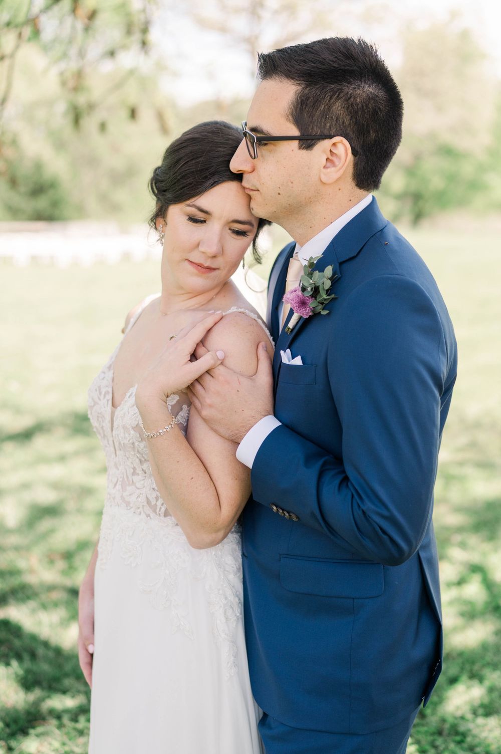 Romantic outdoor wedding portrait capturing an intimate embrace.