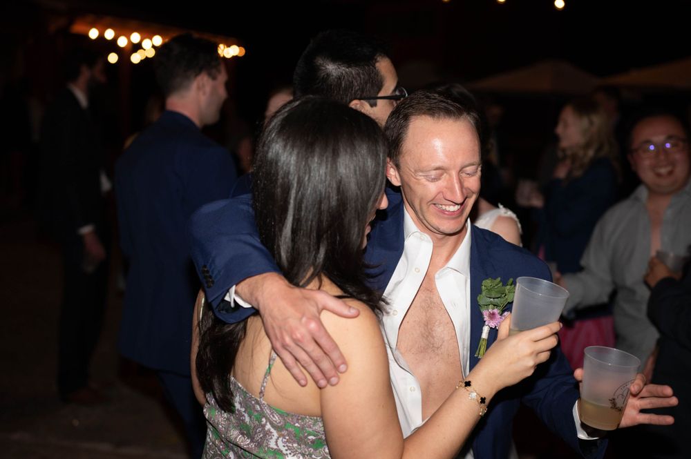 Guests enjoying a lively dance party moment at a dimly lit evening celebration.