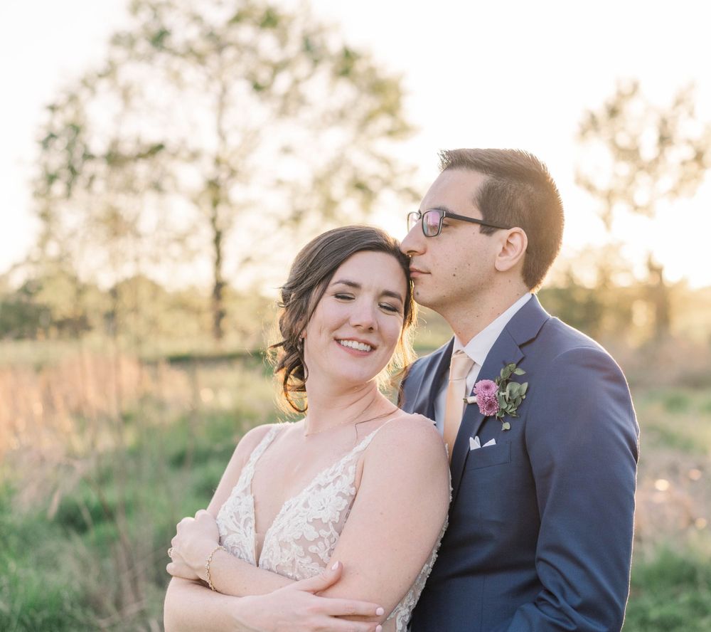 A tender moment between newlyweds sharing a laugh during sunset portrait session. The 1932 Barn Venue, Charlotte, NC