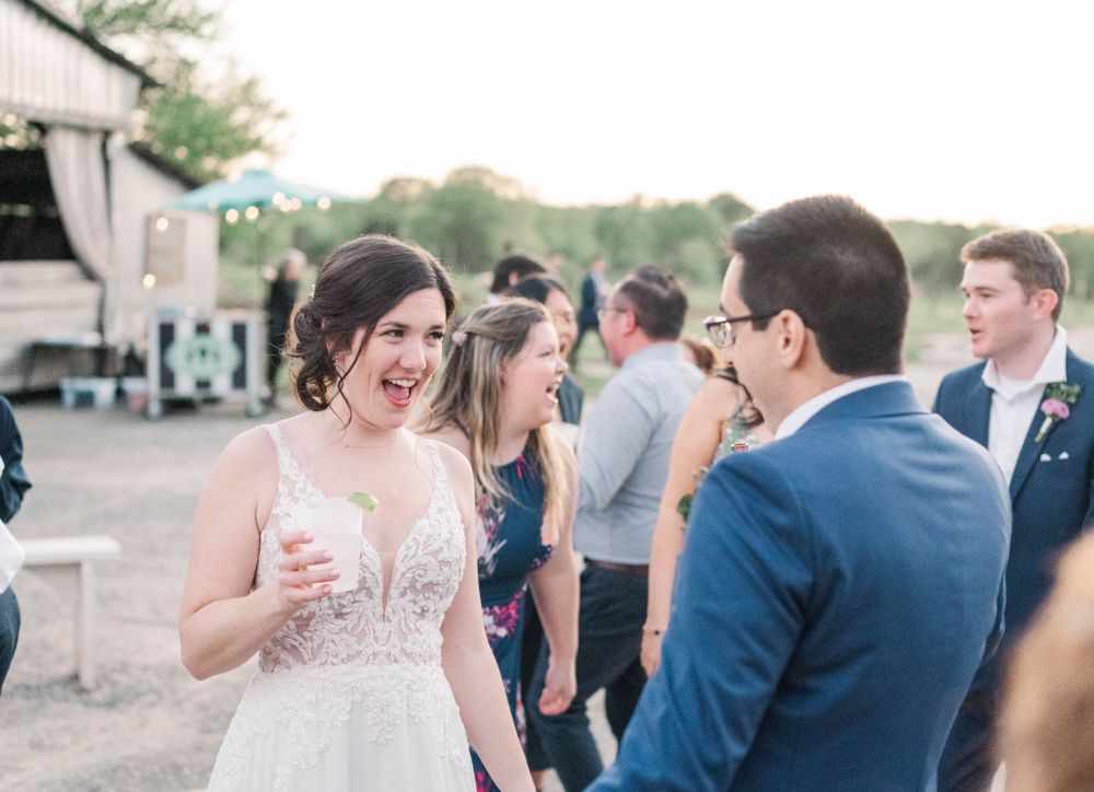 Guests enjoy conversations during an outdoor evening wedding reception.