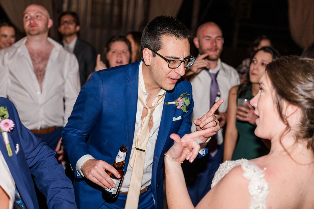 Wedding reception dance floor scene with joyful celebration in full swing. The 1932 Barn Venue, Charlotte, NC