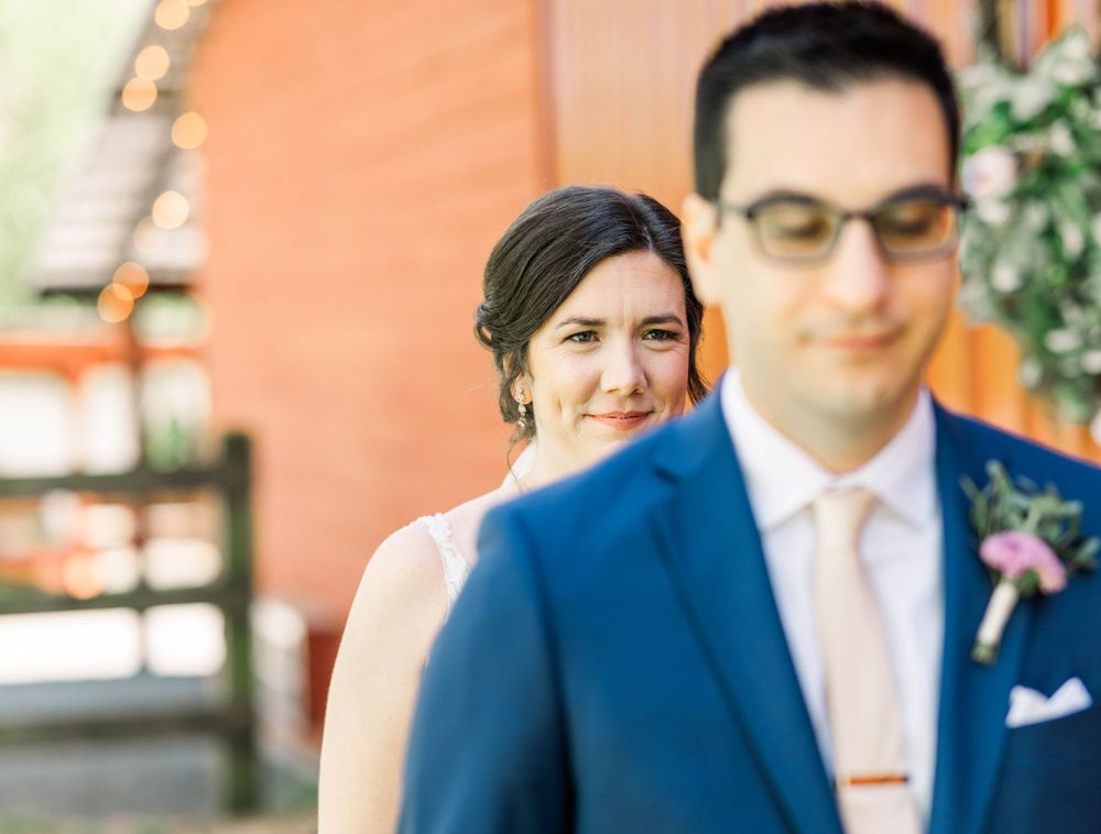 Artistic wedding photo with soft focus and coral colored wall background. The 1932 Barn Venue, Charlotte, NC