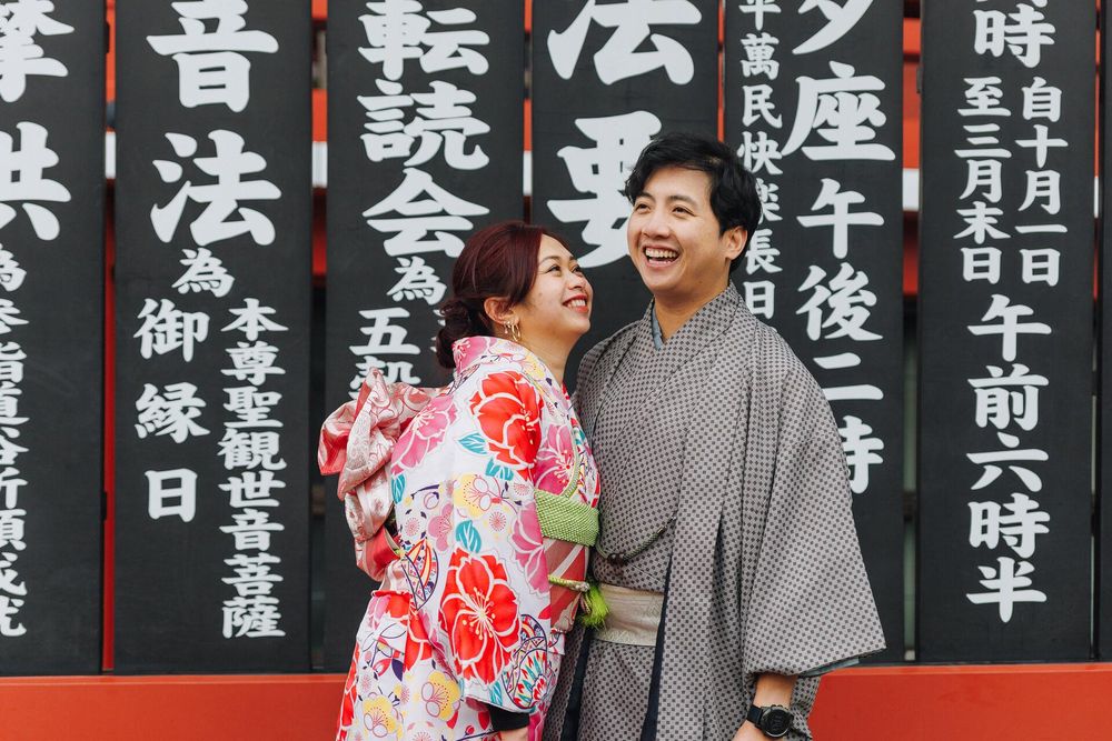 Couple in traditional Japanese attire sharing a moment against black text panels.