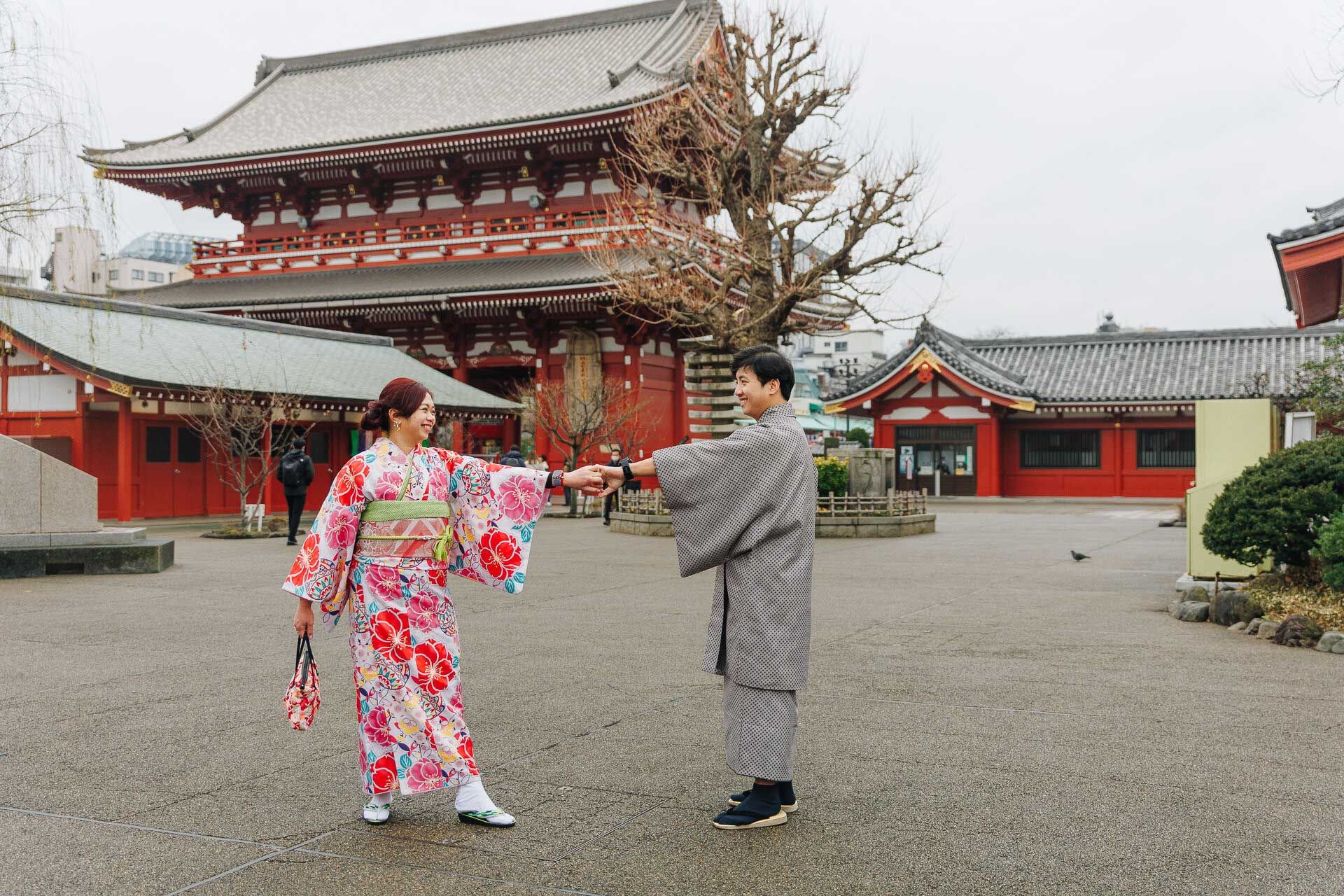 Couple in kimono and hakama posing at a traditional Japanese temple.