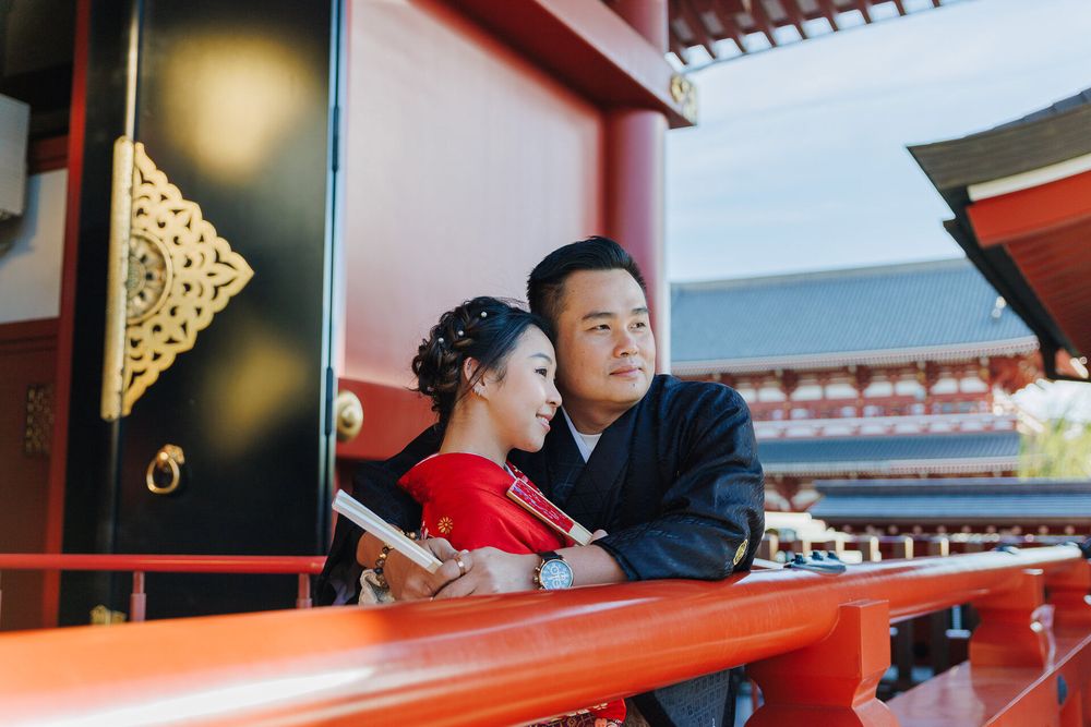 Intimate portrait of couple in traditional Japanese clothing at temple.