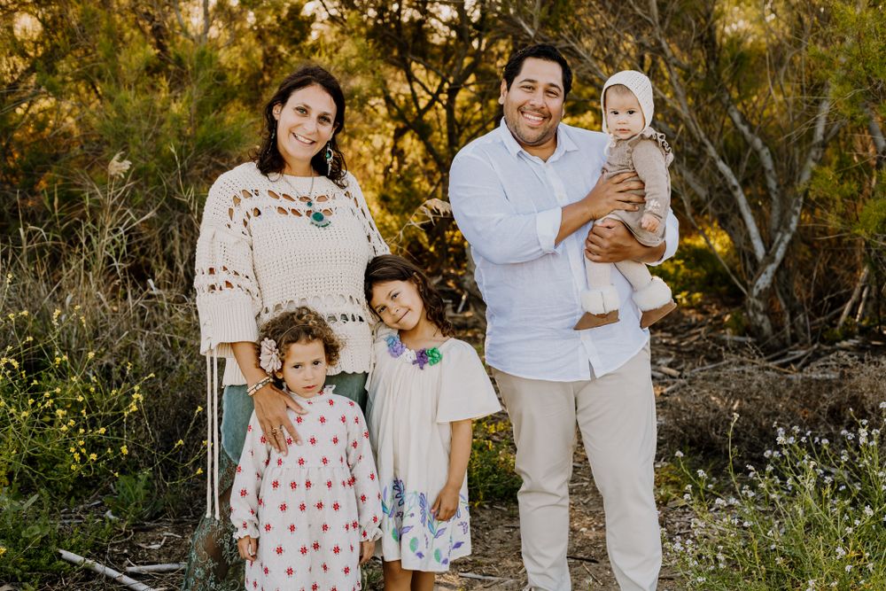 Family picture where everybody together looking at the camera.