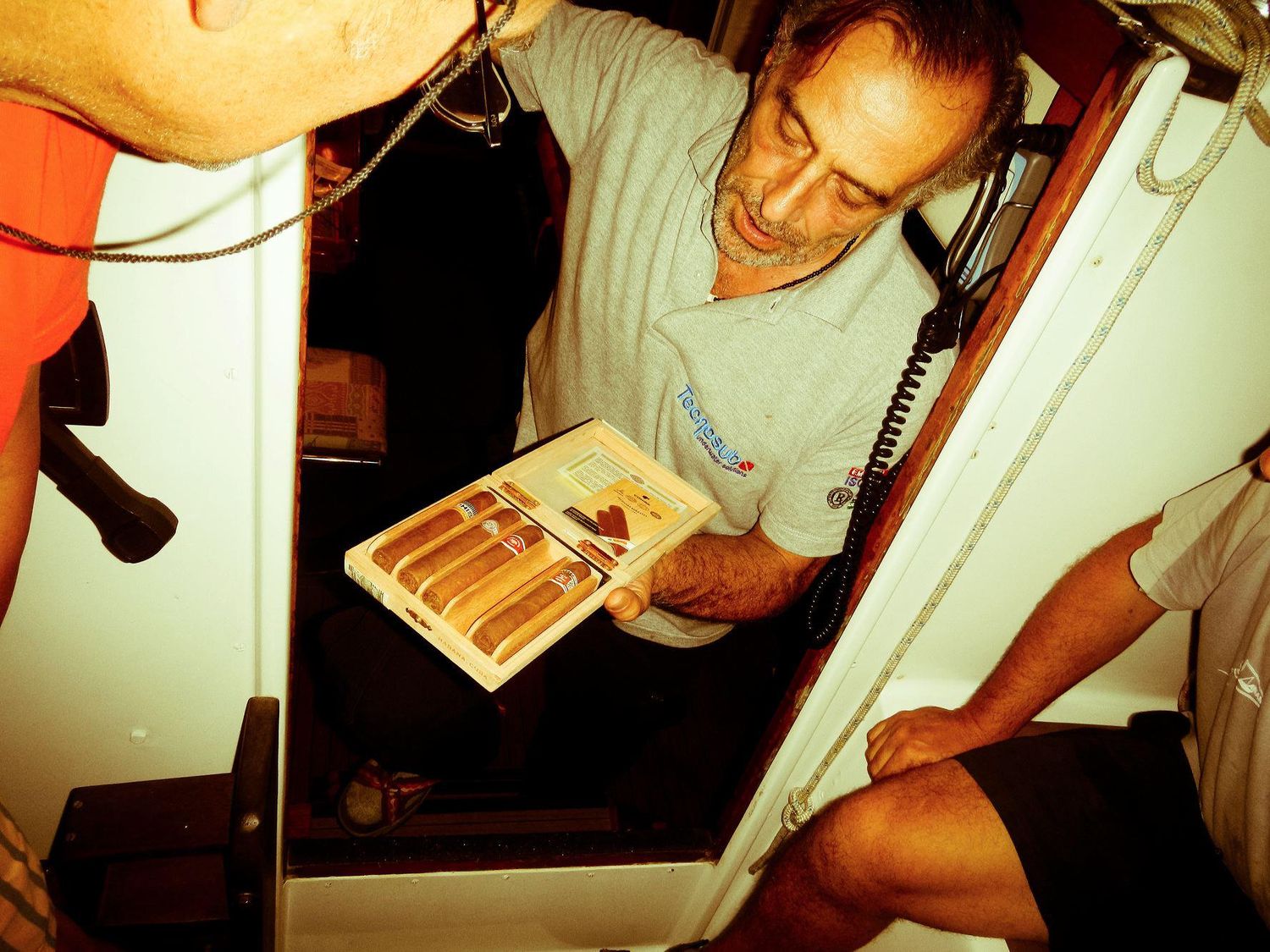 Someone reading below deck in the cabin of a sailing vessel.