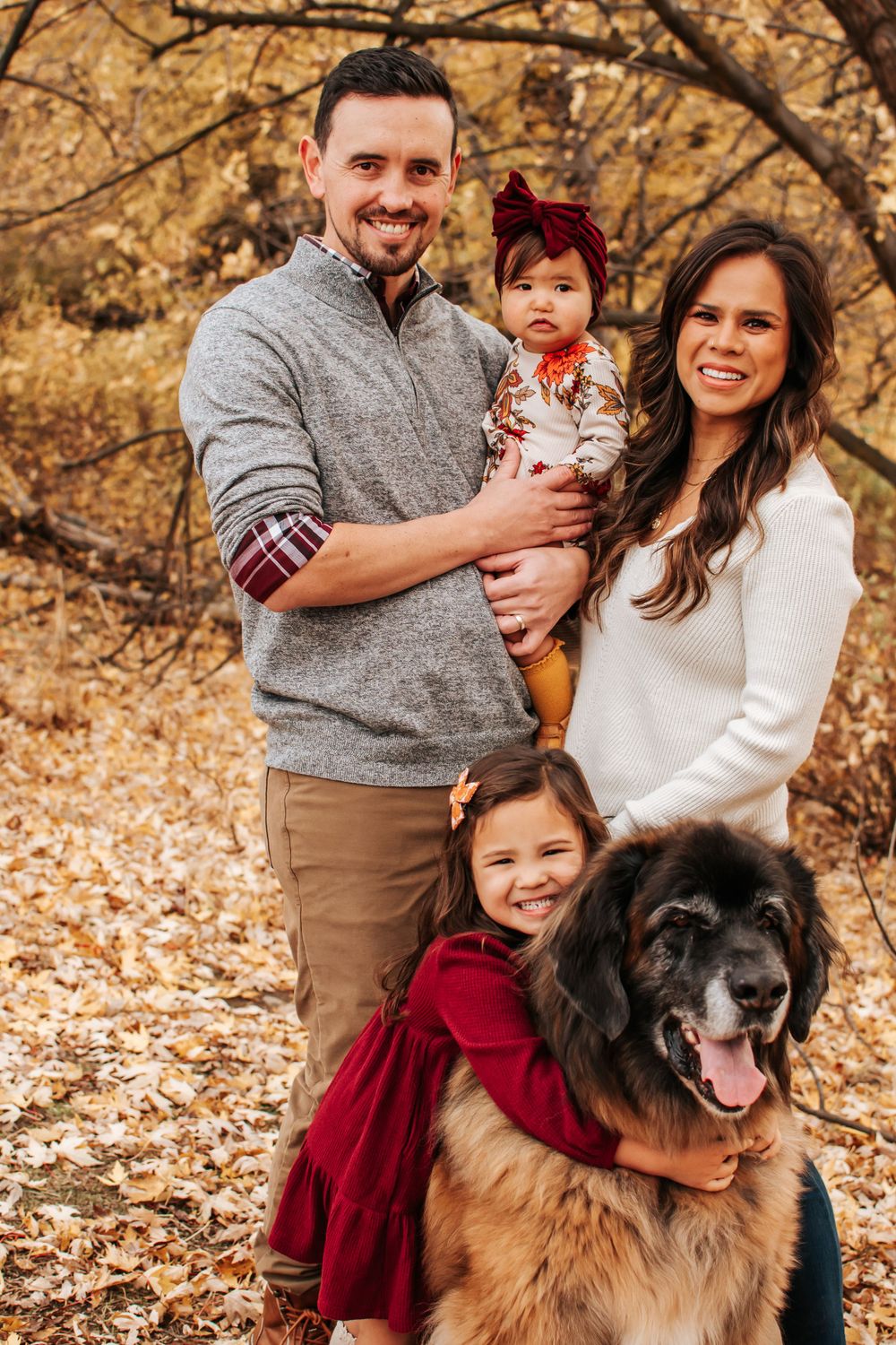 Fall family portrait with famly dog in fallen leaves at Chamna Natural Preserve in Richland, Washington.