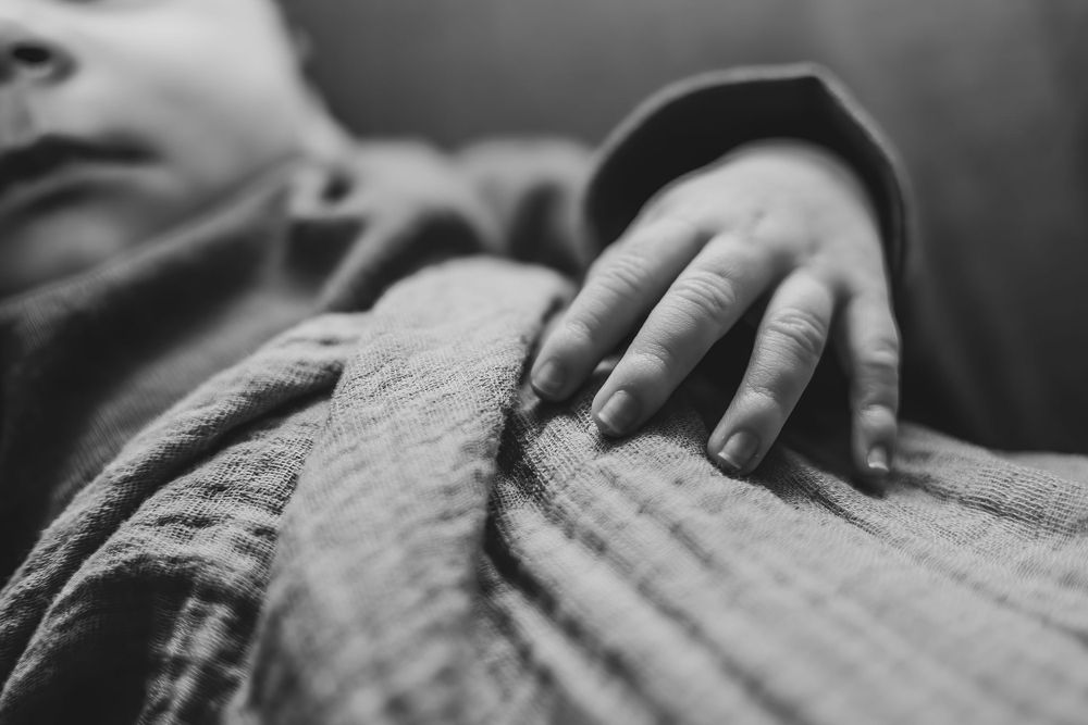 Close-up black and white image of a newborn in a newborn photo in a Tri Cities, Washington photo studio.