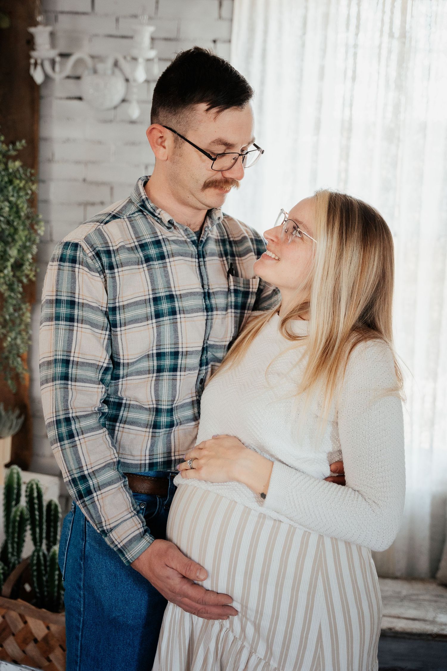 A cozy indoor portrait with a mounted deer head decoration on the wall.