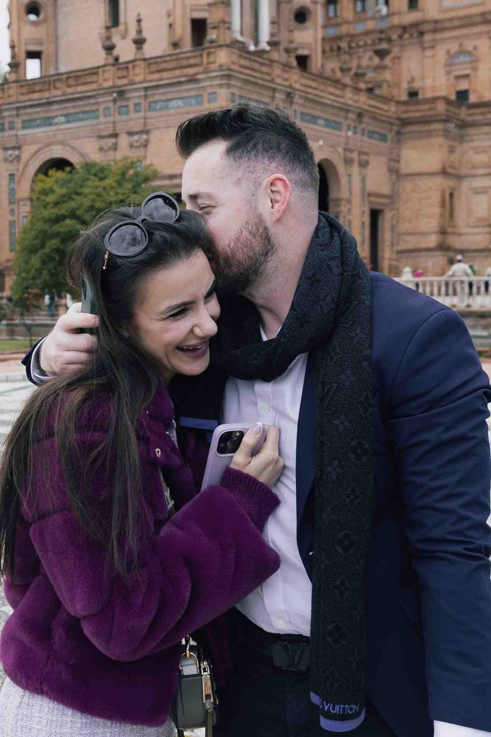 Happy couple sharing intimate moment after proposal at Plaza de España.