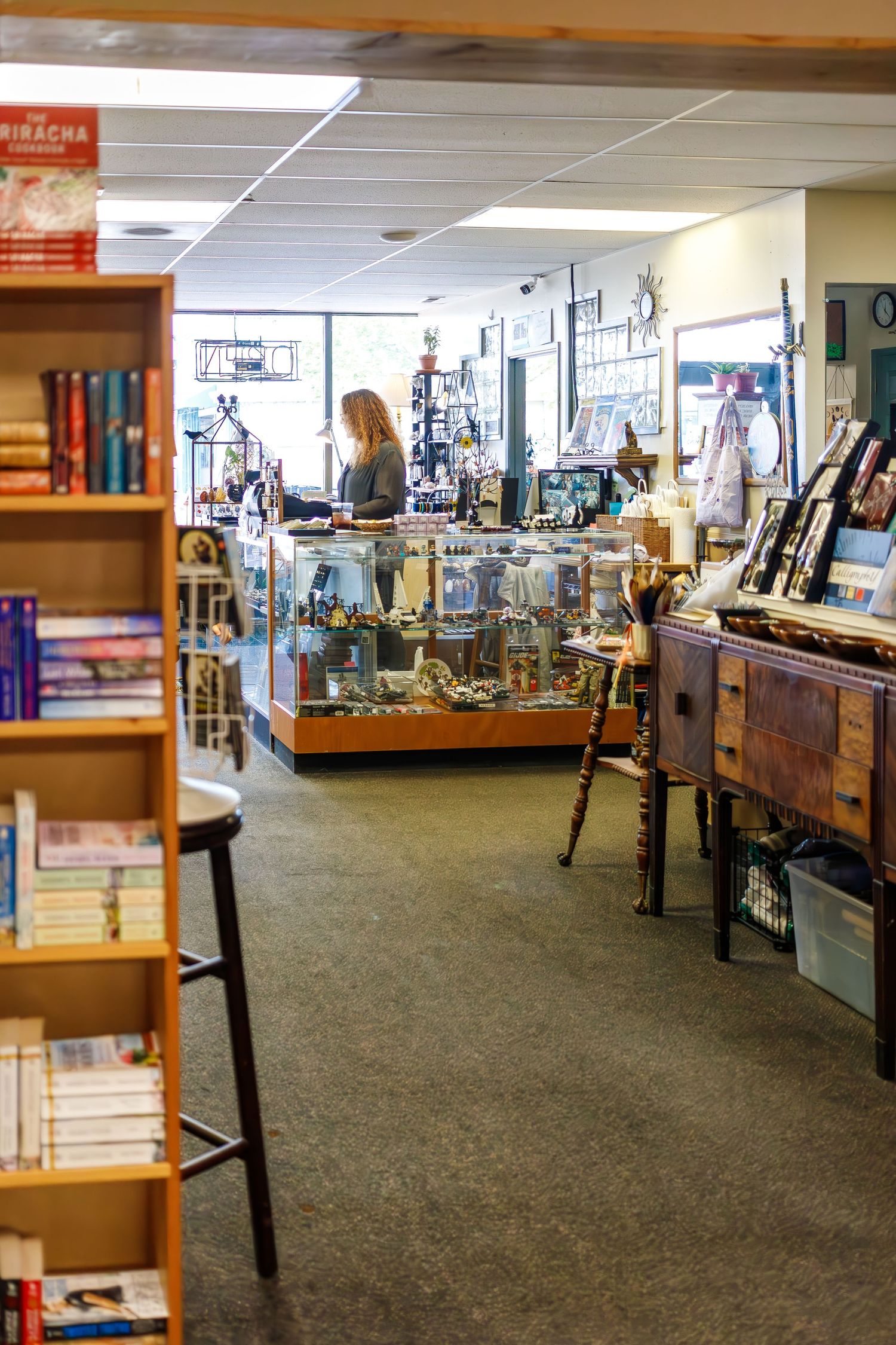 Interior view of bookstore with glass display cases and bookshelves lining the walls.