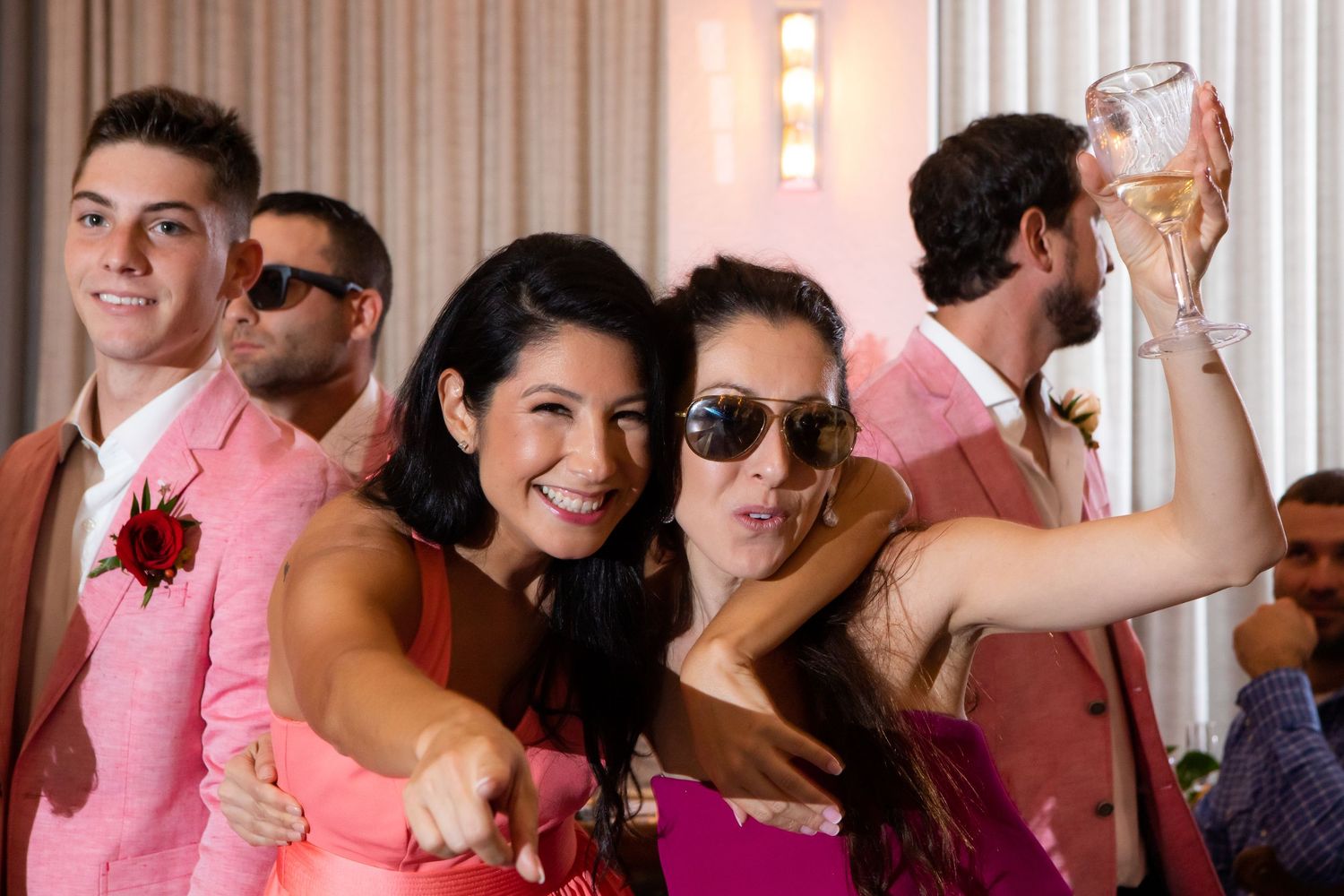 2 bridesmaids cheering the bride