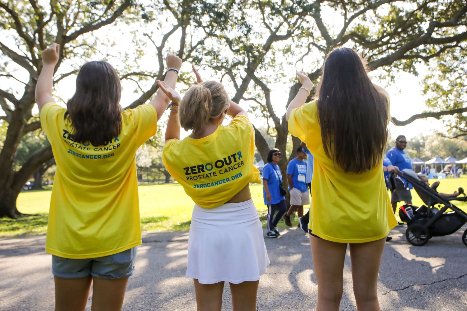 3 girls cheering on runners at charity race, Tampa Florida