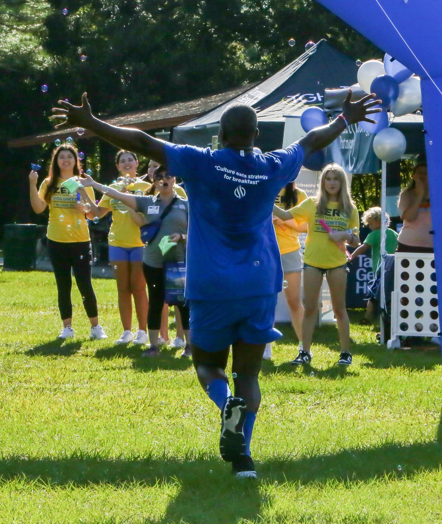 person running across finish line for charity